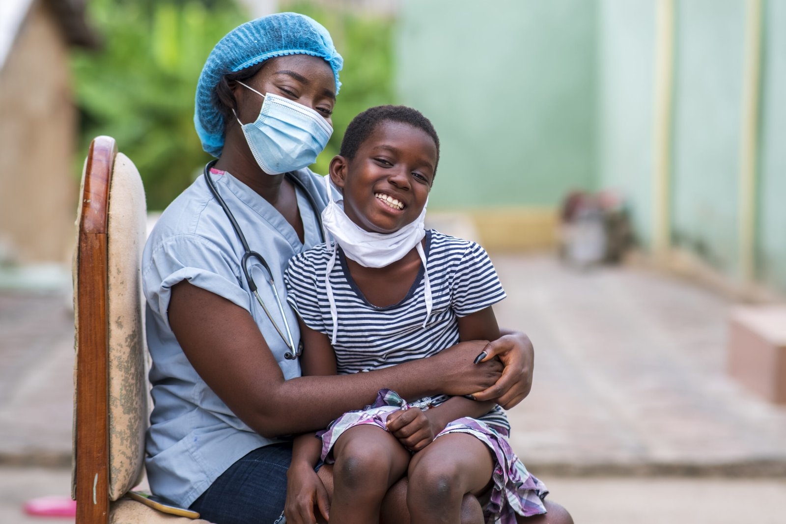 A closeup shot of a boy and a doctor wearing sanitary masks